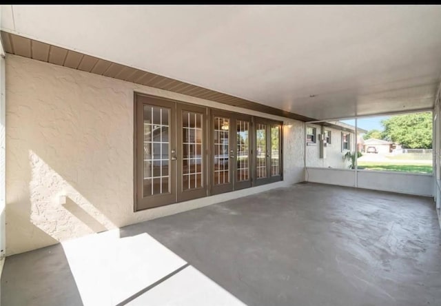 unfurnished sunroom featuring french doors