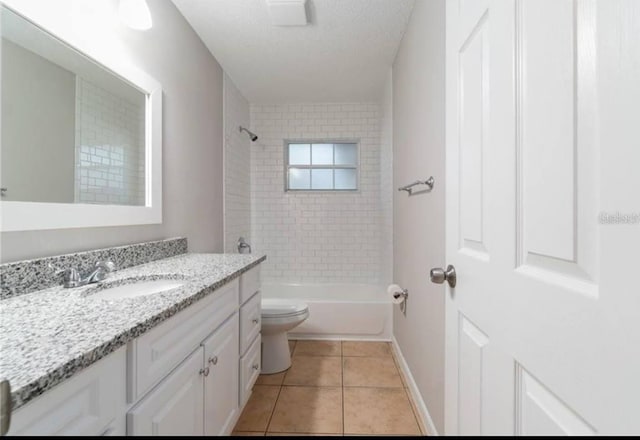 full bathroom with toilet, tiled shower / bath, a textured ceiling, vanity, and tile patterned flooring