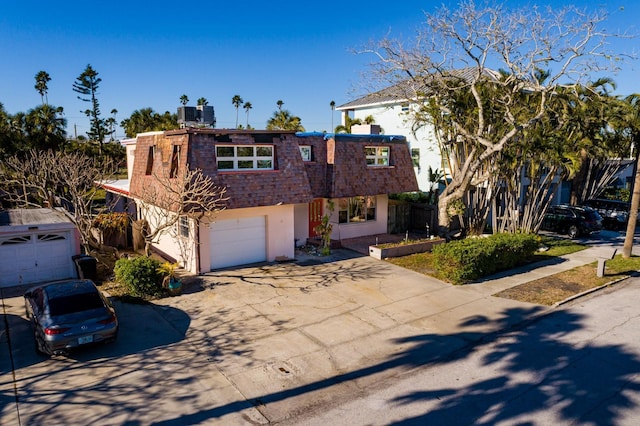 view of front facade featuring a garage and central AC