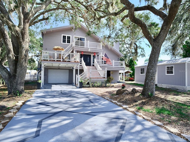 beach home with a garage and an outdoor structure