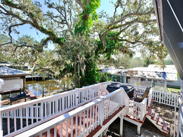 dock area featuring a deck with water view