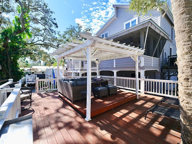 deck with a sunroom, an outdoor hangout area, and a pergola