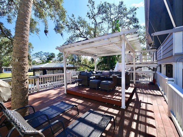 wooden terrace with outdoor lounge area and a pergola