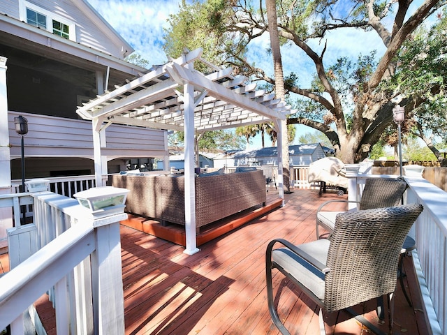 wooden terrace with an outdoor living space and a pergola