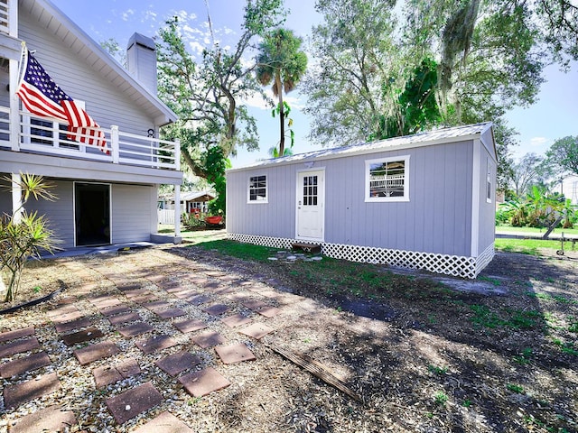 rear view of property featuring a patio area