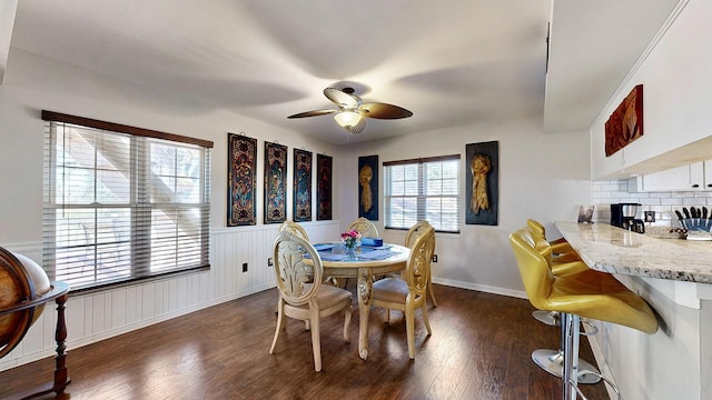 dining area with dark wood-type flooring and ceiling fan