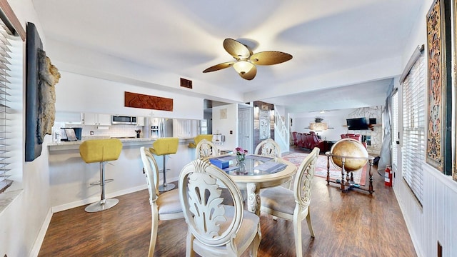 dining room with ceiling fan and dark hardwood / wood-style floors