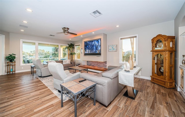 living room featuring ceiling fan, a healthy amount of sunlight, and light hardwood / wood-style flooring