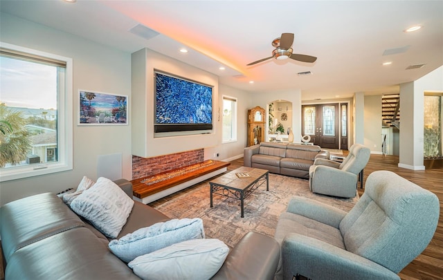 living room with ceiling fan and hardwood / wood-style floors