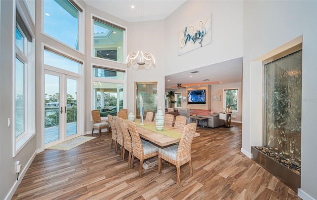 dining room with hardwood / wood-style flooring and french doors