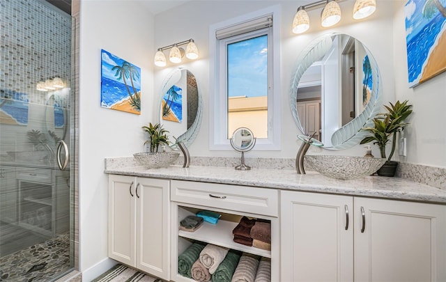 bathroom featuring vanity and a shower with shower door