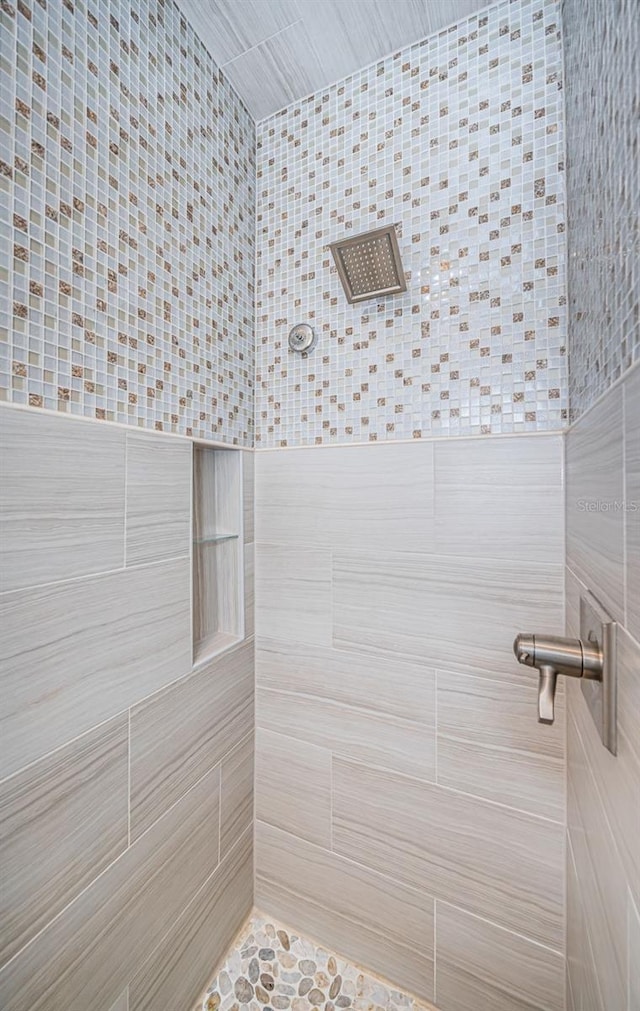 bathroom with tiled shower