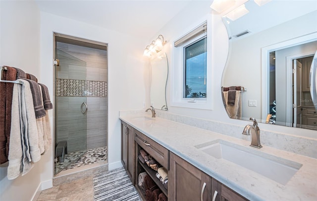 bathroom with vanity and a shower with door