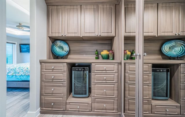 kitchen featuring beverage cooler and light hardwood / wood-style floors