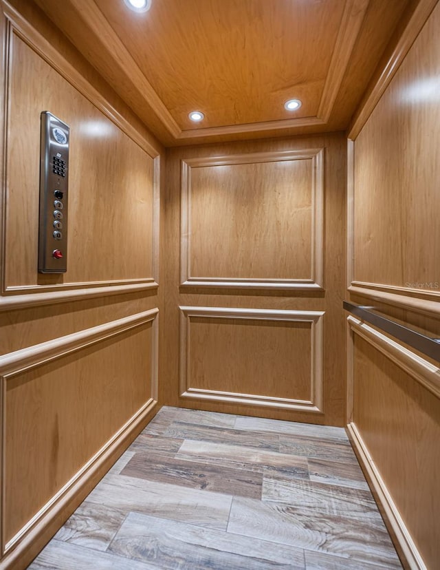 details with hardwood / wood-style flooring, elevator, and wooden ceiling