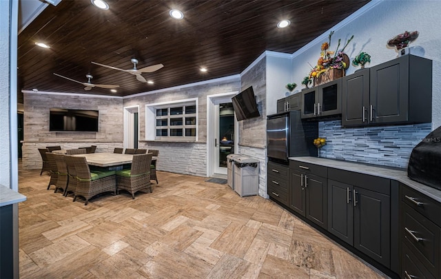 kitchen featuring tasteful backsplash, crown molding, wooden ceiling, and refrigerator