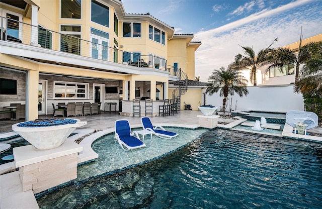 view of swimming pool with a hot tub, a patio area, and a bar