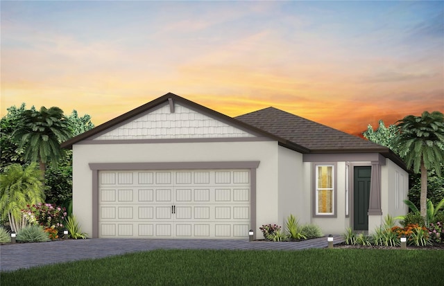 view of front of property featuring a garage and a lawn