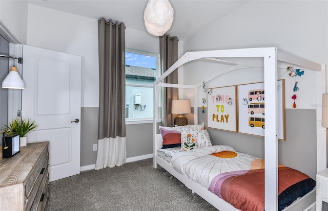 bedroom with lofted ceiling and dark carpet