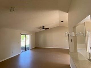 empty room featuring vaulted ceiling and ceiling fan