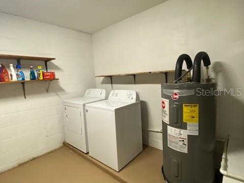 washroom featuring washing machine and dryer and water heater