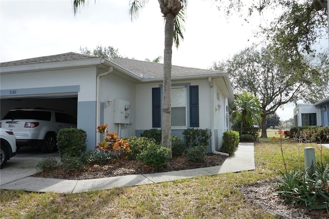 view of side of home with a garage and a yard