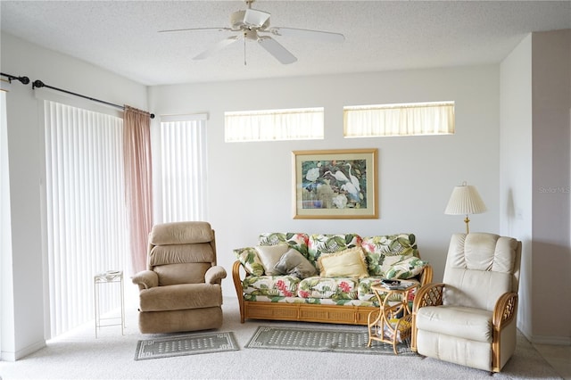 living room featuring plenty of natural light, carpet floors, and a textured ceiling