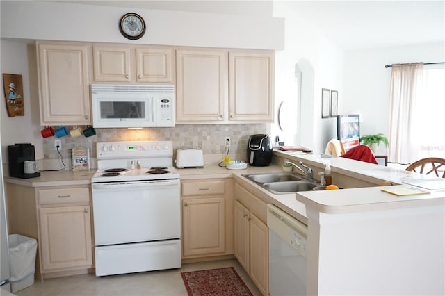 kitchen featuring light brown cabinetry, sink, tasteful backsplash, kitchen peninsula, and white appliances