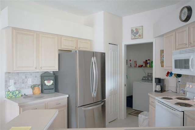 kitchen featuring cream cabinets, washer / dryer, white appliances, and decorative backsplash