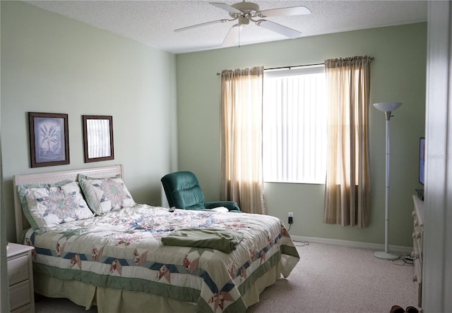 bedroom with carpet, a textured ceiling, and ceiling fan