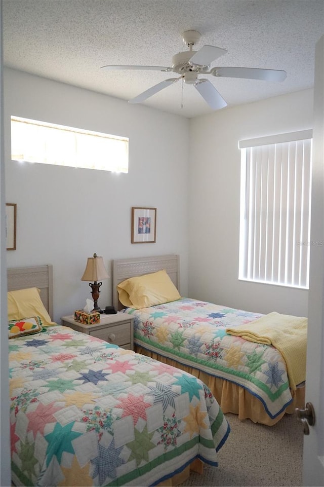 bedroom featuring ceiling fan and a textured ceiling