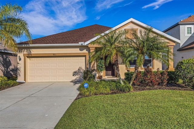 single story home with driveway, a front lawn, an attached garage, and stucco siding