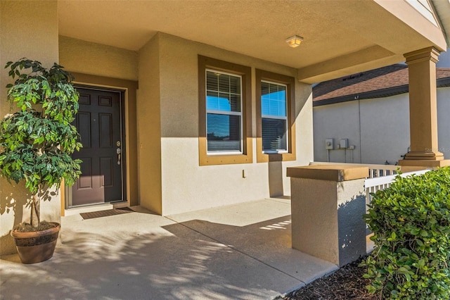 property entrance with stucco siding