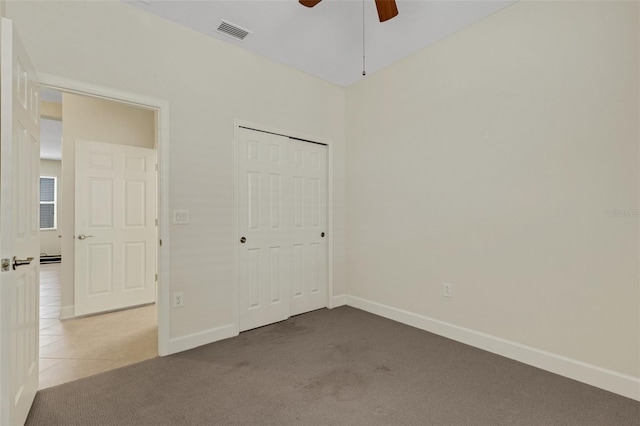 unfurnished bedroom with light colored carpet, visible vents, baseboards, and light tile patterned flooring