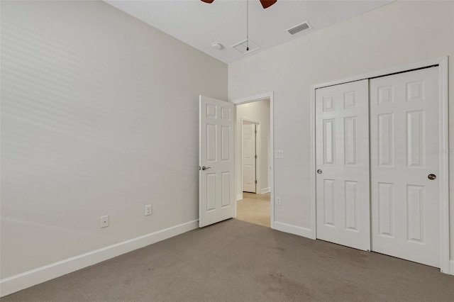 unfurnished bedroom featuring carpet, a closet, visible vents, and baseboards