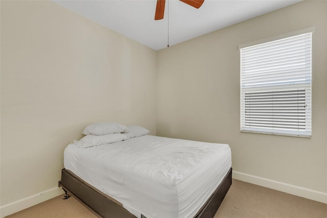 carpeted bedroom featuring a ceiling fan and baseboards