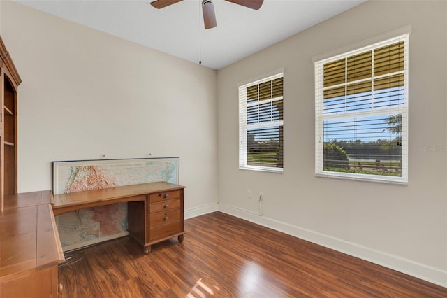 unfurnished office featuring ceiling fan, wood finished floors, and baseboards