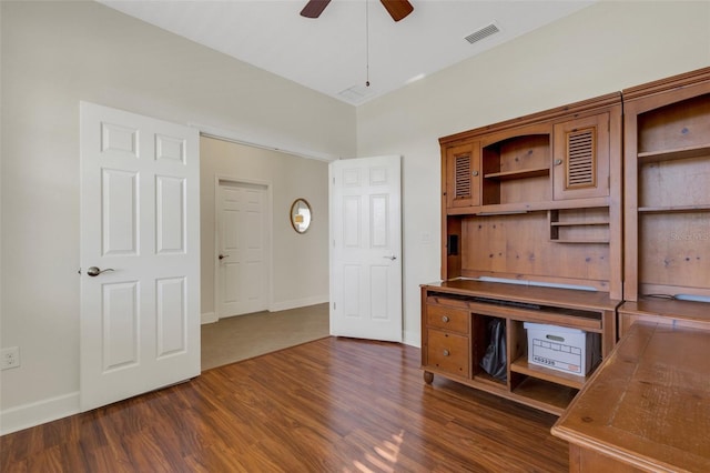 unfurnished office featuring baseboards, dark wood finished floors, visible vents, and a ceiling fan