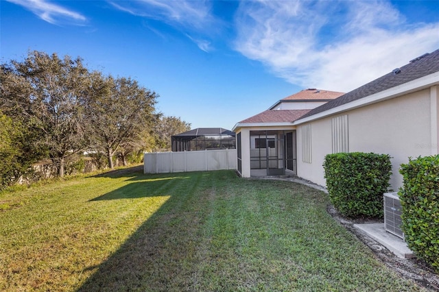 view of yard featuring a sunroom and fence