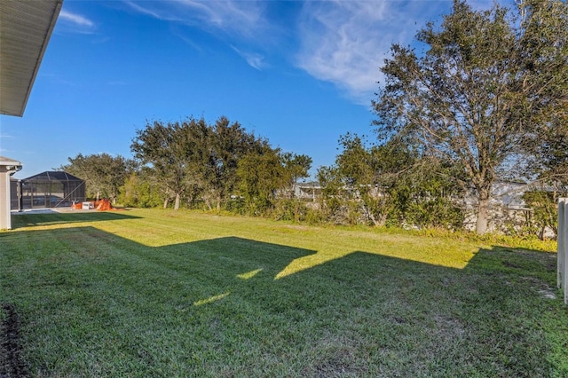 view of yard featuring glass enclosure