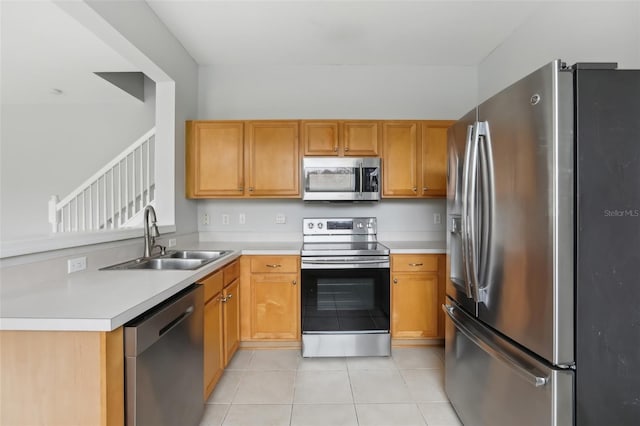 kitchen featuring stainless steel appliances, sink, and light tile patterned floors