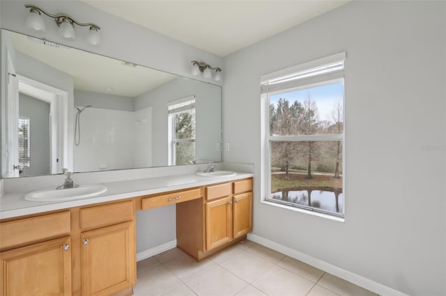 bathroom with vanity, plenty of natural light, and tile patterned floors