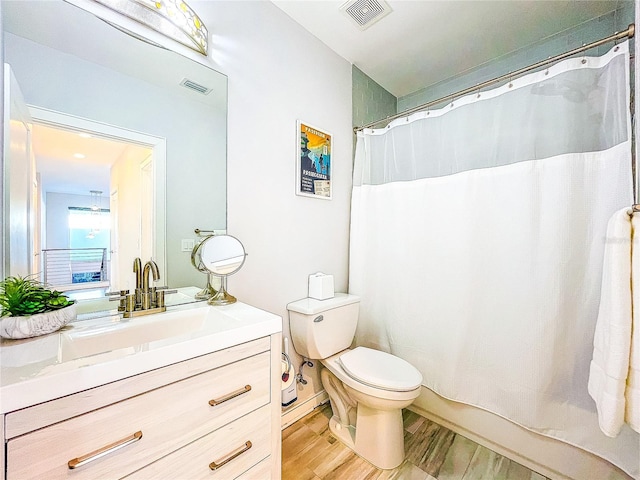 bathroom featuring a shower with curtain, wood-type flooring, vanity, and toilet