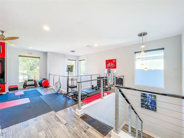 exercise area with recessed lighting and wood finished floors