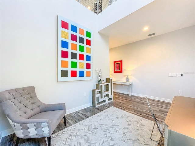 sitting room featuring visible vents, wood finished floors, and baseboards