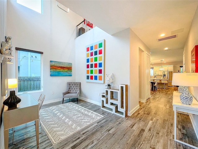 sitting room with wood-type flooring