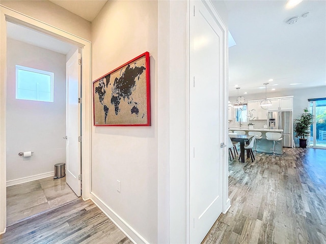 corridor with light hardwood / wood-style flooring