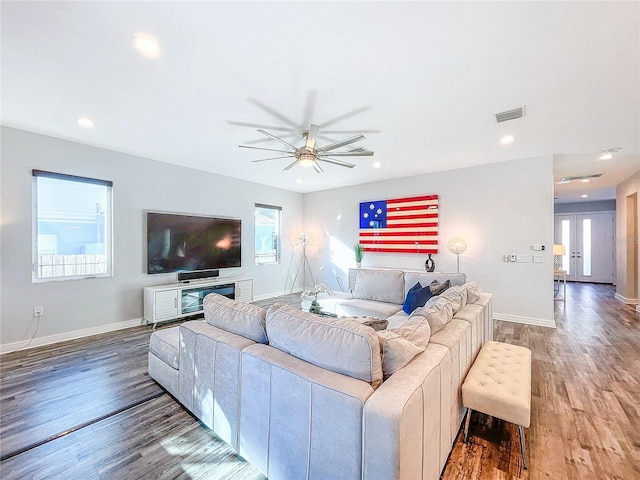 living room with hardwood / wood-style flooring and ceiling fan