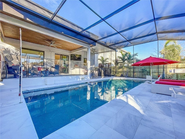 view of pool with a lanai, a patio, and ceiling fan