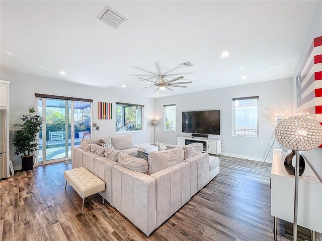 living room featuring ceiling fan and hardwood / wood-style floors